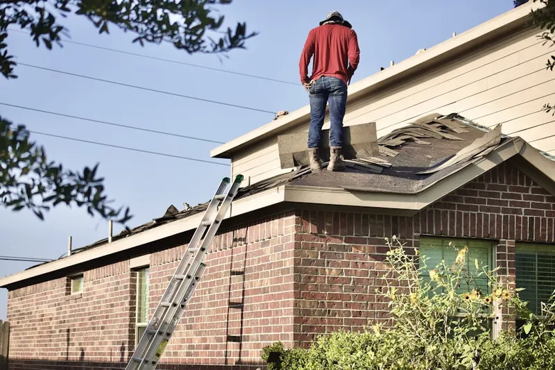 Professional roofer working on a residential roof in Ashton Village